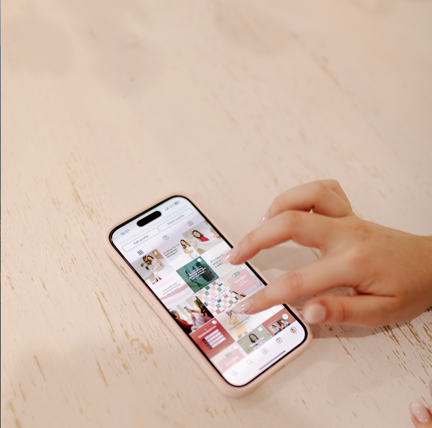 Hand scrolling through social media feed on smartphone, demonstrating strategic social media engagement and caption writing